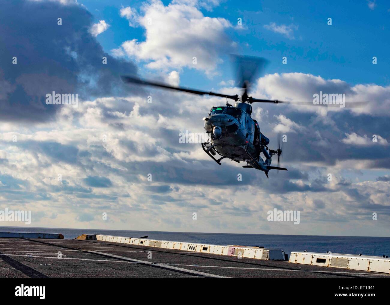 190221-N-HG389-0042 MEDITERRANEAN SEA (Feb. 21, 2019) A UH-1Y Huey helicopter assigned to the “Black Knights” of Marine Medium Tiltrotor Squadron (VMM) 264 (Reinforced) prepares to land on the flight deck of the San Antonio-class amphibious transport dock ship USS Arlington (LPD 24), Feb. 21, 2019. Arlington is on a scheduled deployment as part of the Kearsarge Amphibious Ready Group in support of maritime security operations, crisis response and theater security cooperation, while also providing a forward naval presence. (U.S. Navy photo by Mass Communication Specialist 2nd Class Brandon Park Stock Photo