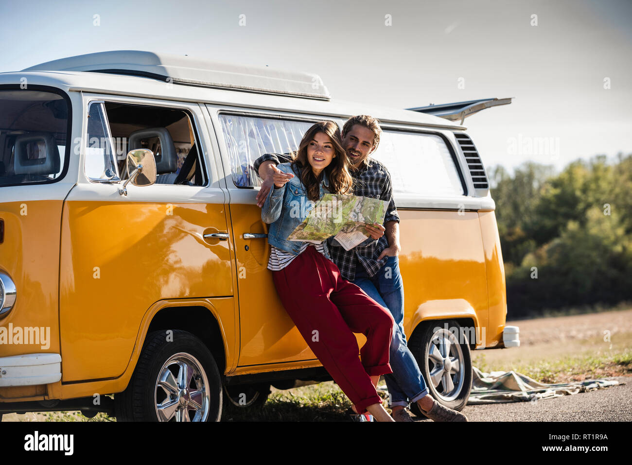 Couple on a road trip in their camper, looking at map Stock Photo