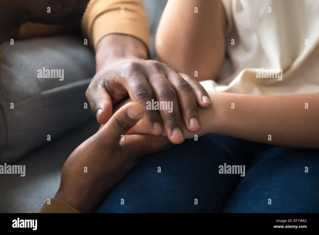 African father holding hands of child as charity support concept Stock Photo
