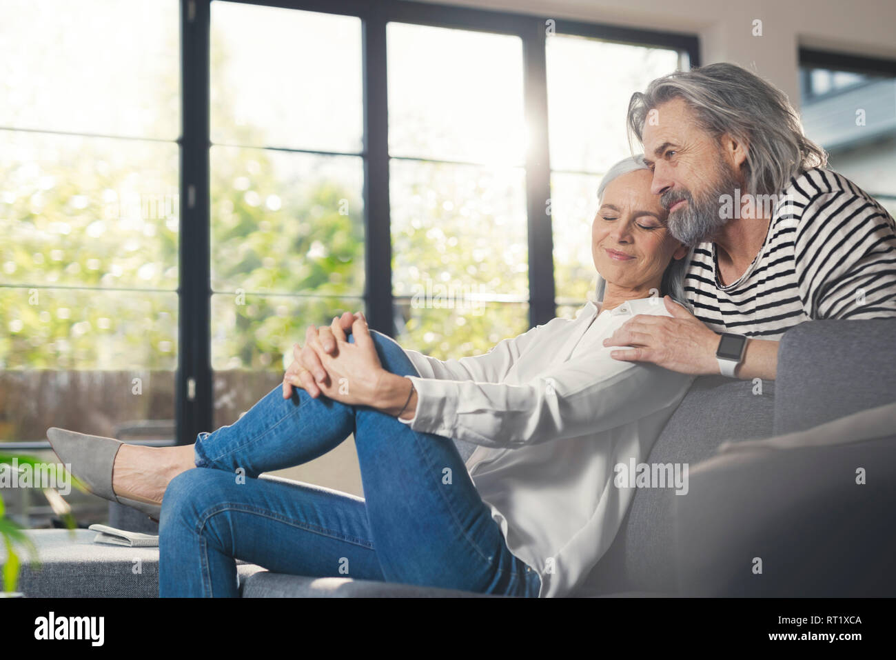 Happy senior couple sitting at home Stock Photo