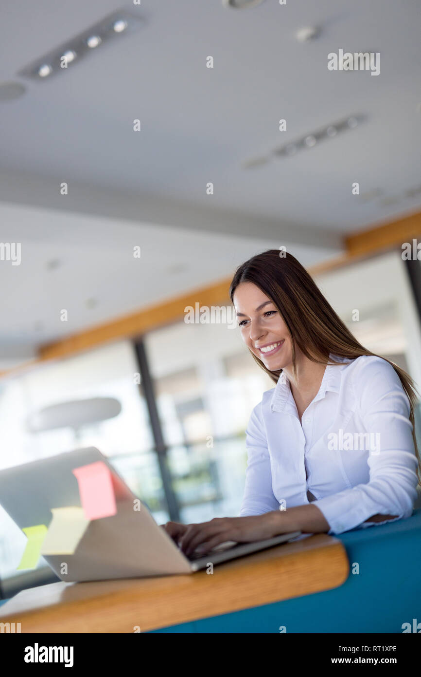 Smiling female office employee hi-res stock photography and images - Alamy