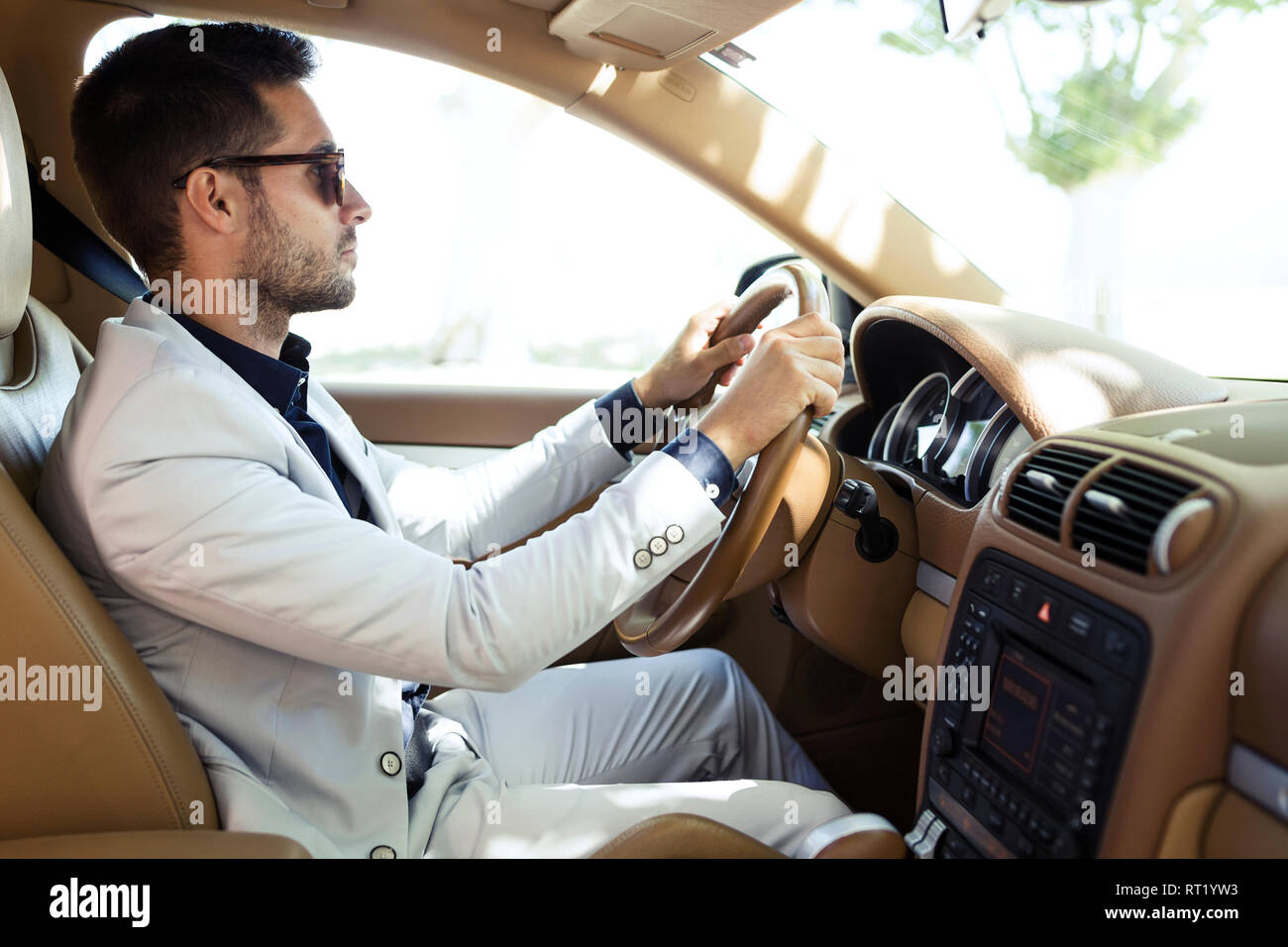 Successful young businessman driving in his car Stock Photo