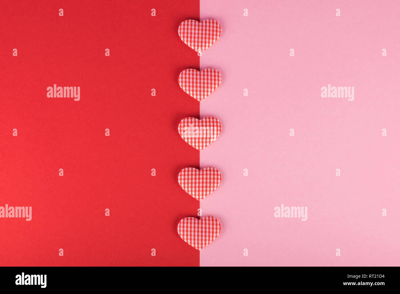 Two color red and pink background with small checkered hearts Stock Photo