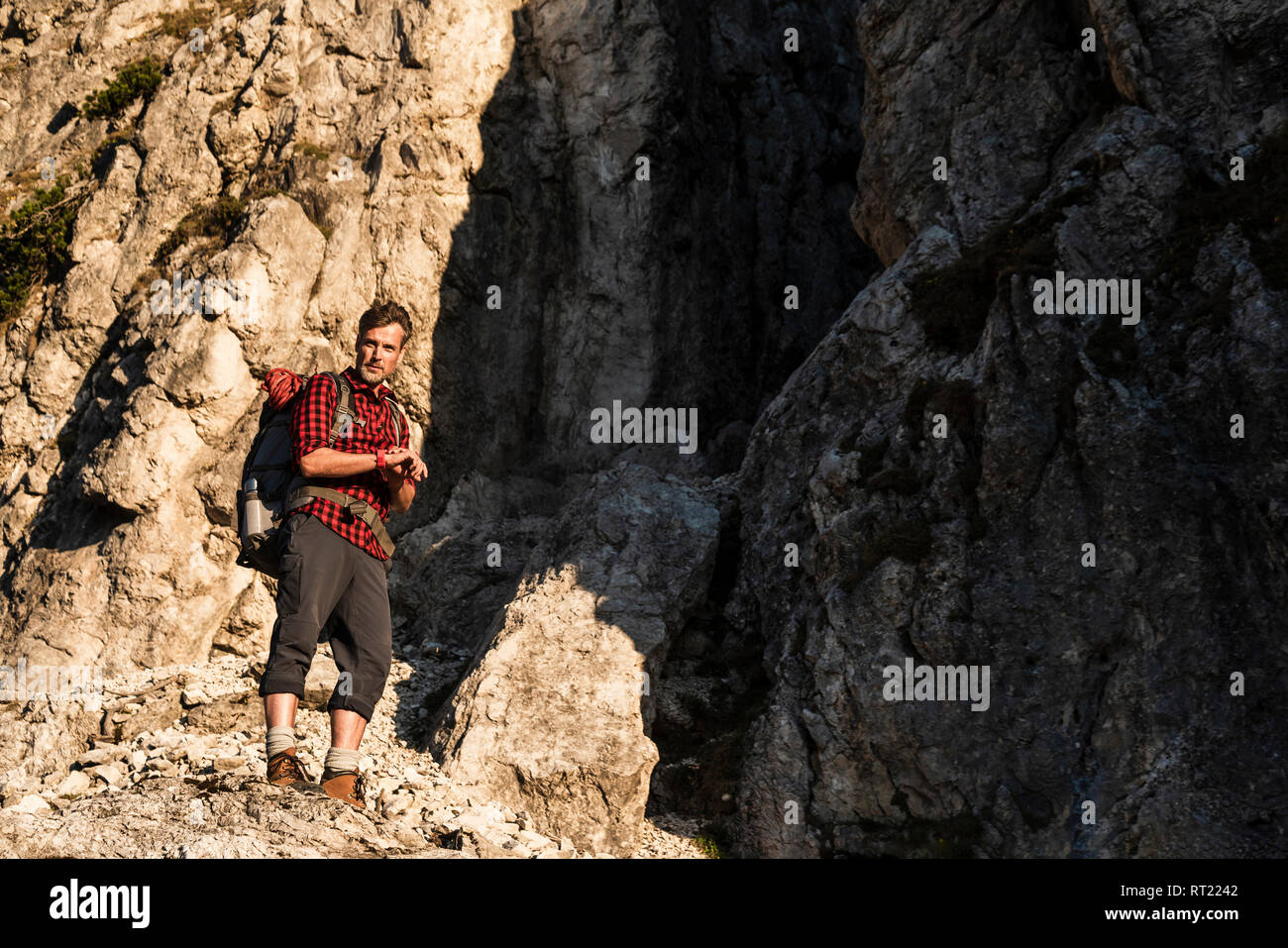 Mature man standing in the mountains, mountaineering in Austria Stock Photo