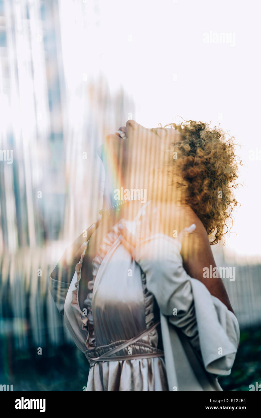 Happy attractive young woman with reflections wearing a dress Stock Photo