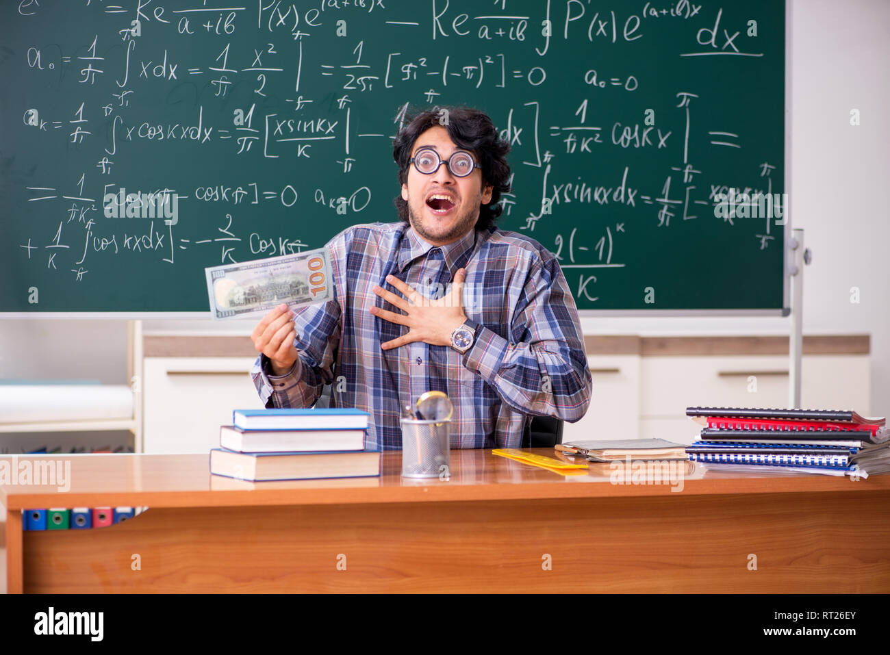 Funny male math teacher in the classroom Stock Photo - Alamy