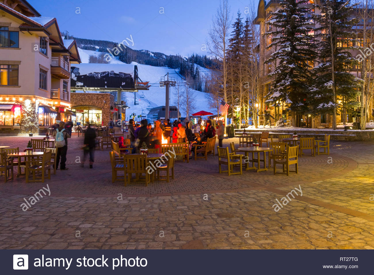 People Gathered Around An Outdoor Fire On A Cold December
