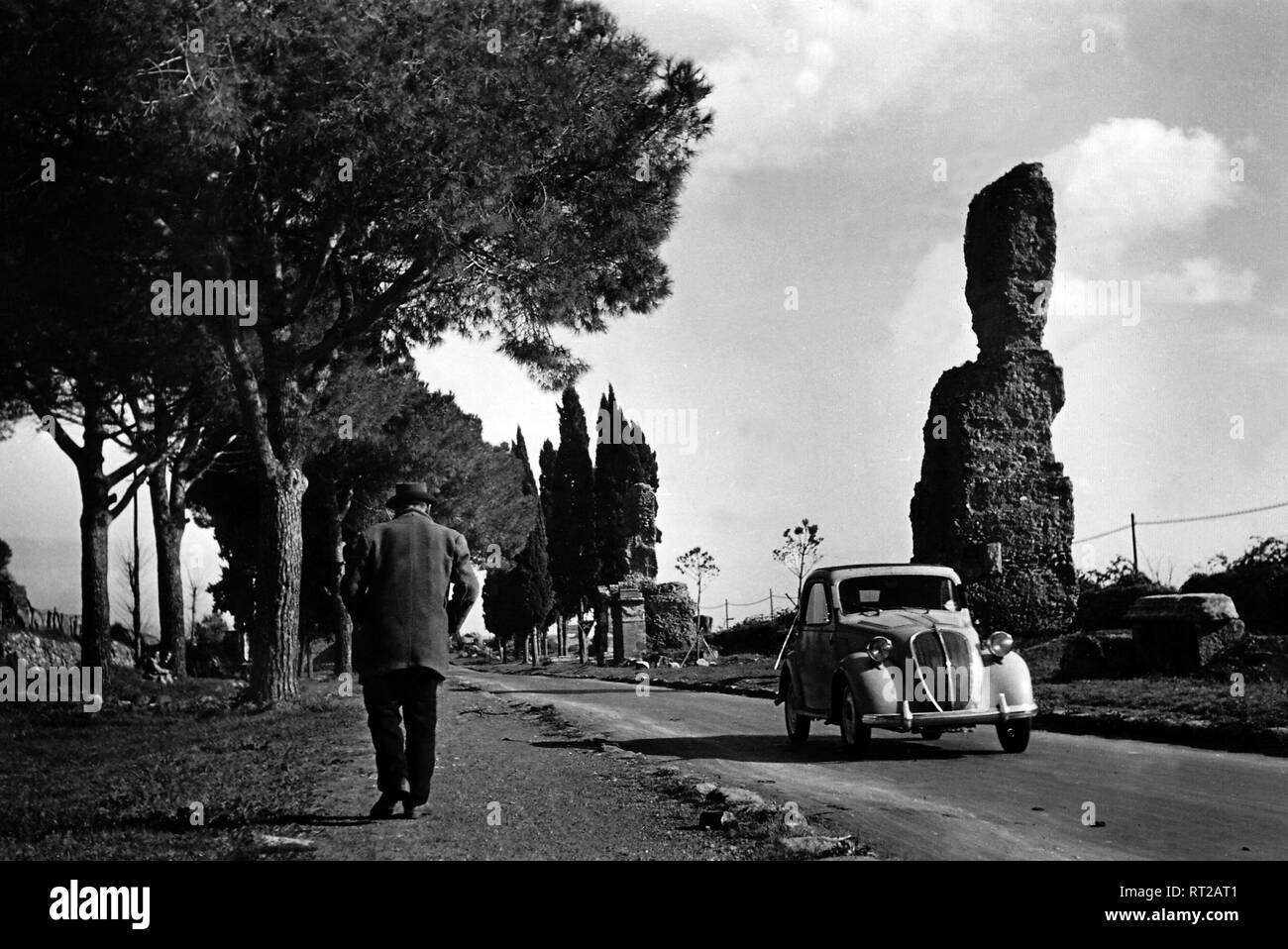 Travel to Rome - Italy in 1950s - Fiat Topolino on the Via Appia Antica near Rome. Auf der Via Appia Antica bei Rom, Italien. Image taken in 1954 by Erich Andres Stock Photo