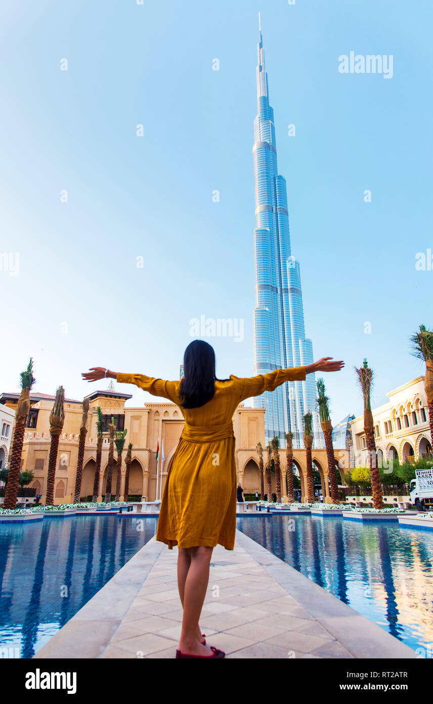 Female tourist in front of Dubai landmark, United Arab Emirates Stock Photo