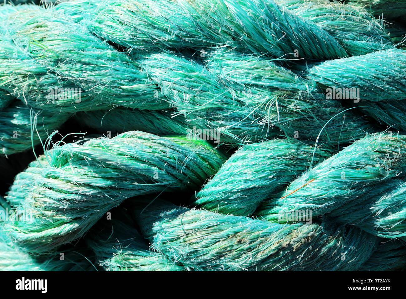 Big fat blue mooring rope texture. Nautical marine background. Stock Photo