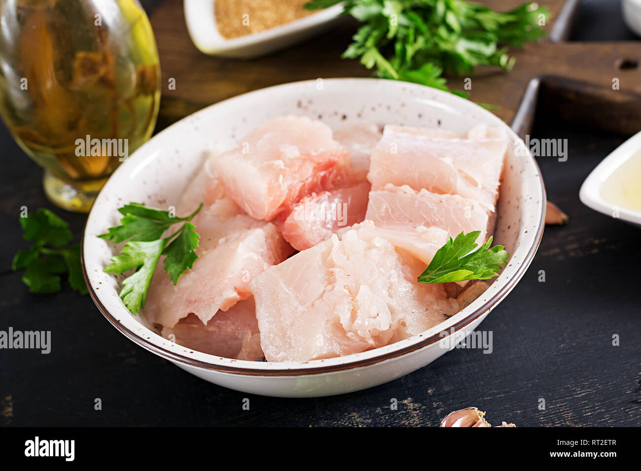 Ingredients for homemade Fish Cake cod, spinach, egg and breadcrumbs. Raw cutlets from minced cod. Stock Photo