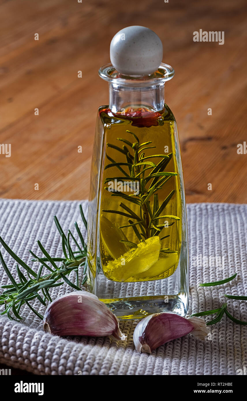 Olive oil flavored with garlic chilies and rosemary Stock Photo - Alamy