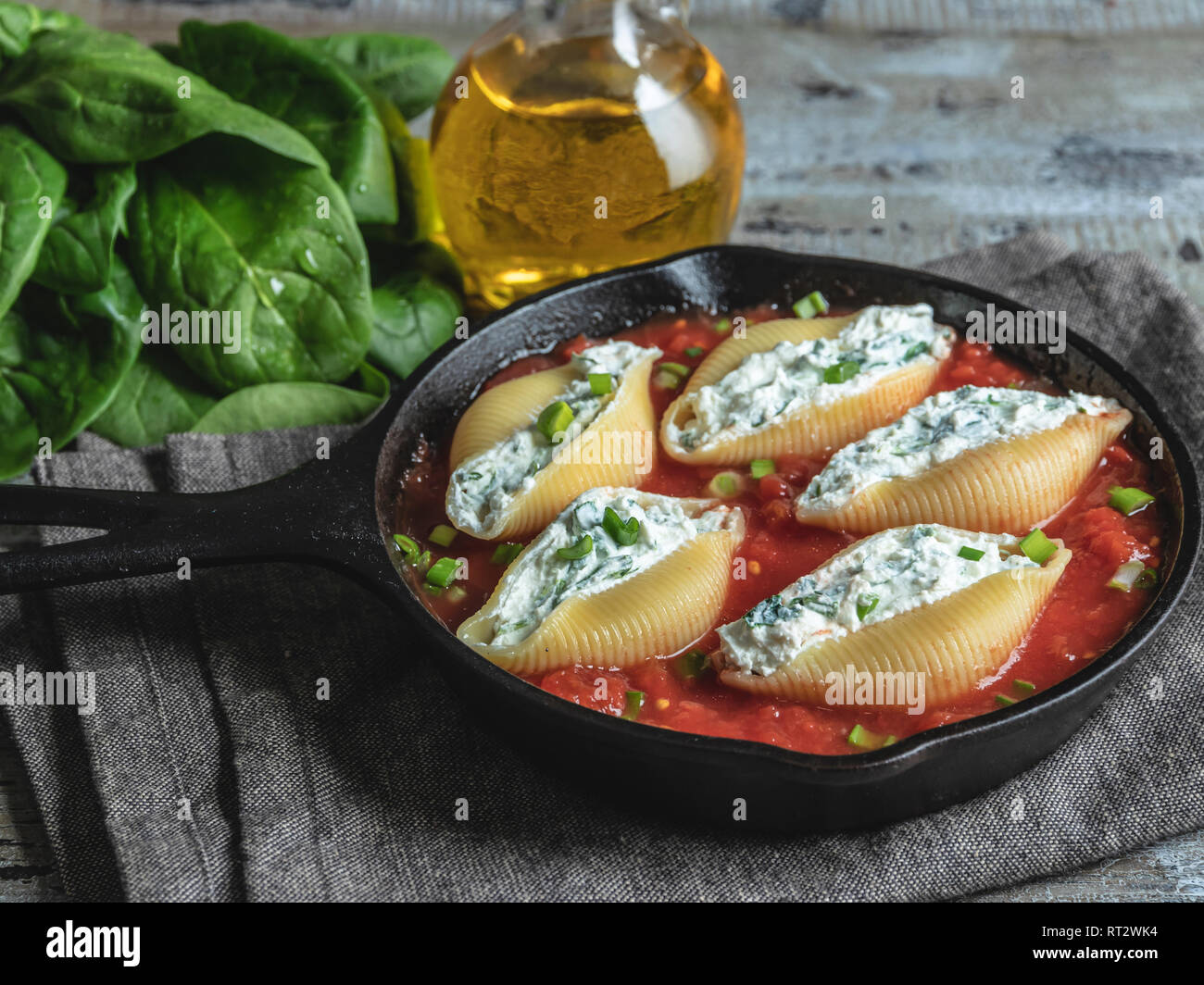 pasta conchiglioni stuffed spinach and cheese, tomato sauce cooked Stock Photo