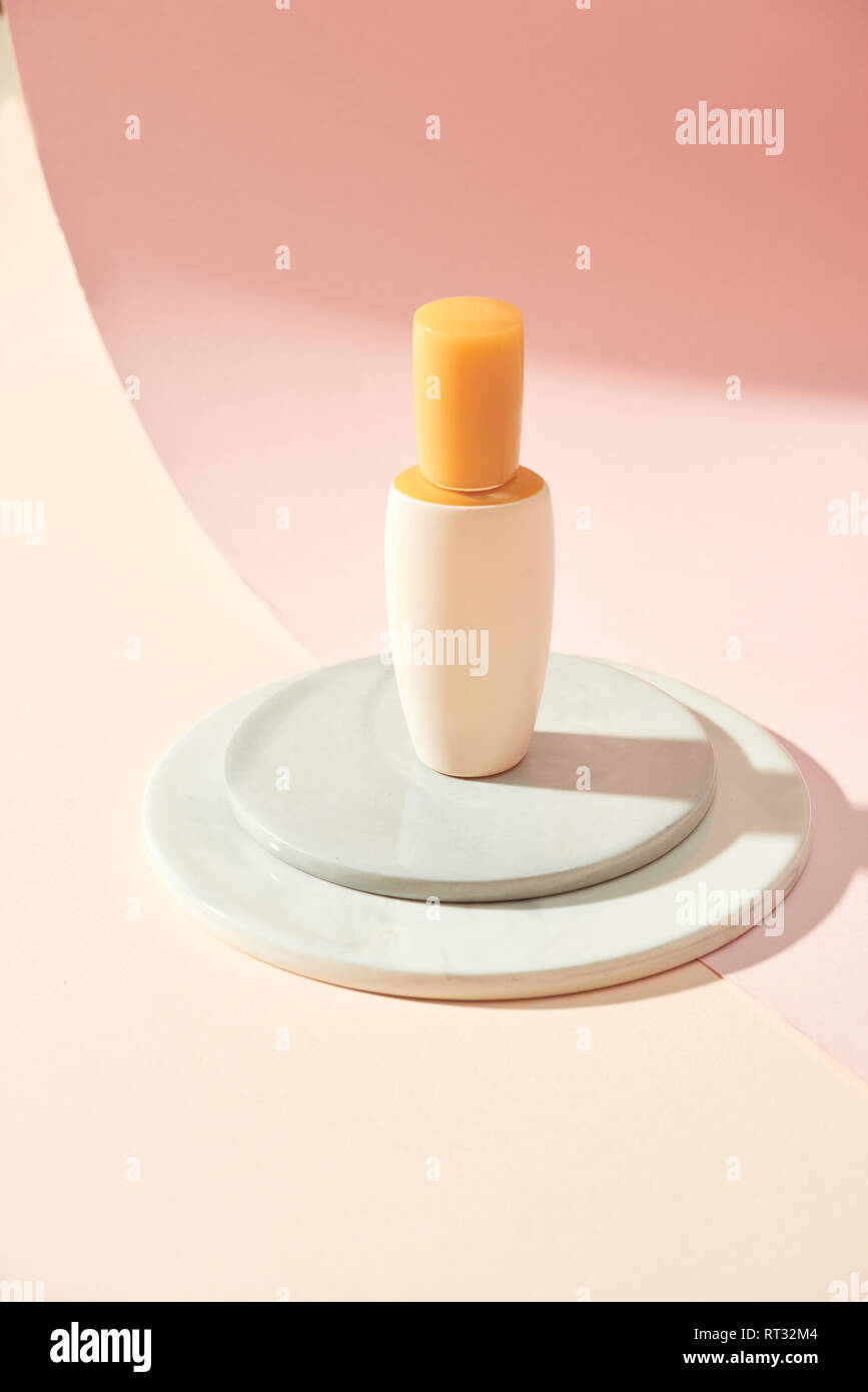 Skincare product serum bottle mockup sample styling on beige table with pink paper. Product studio styling shot Stock Photo