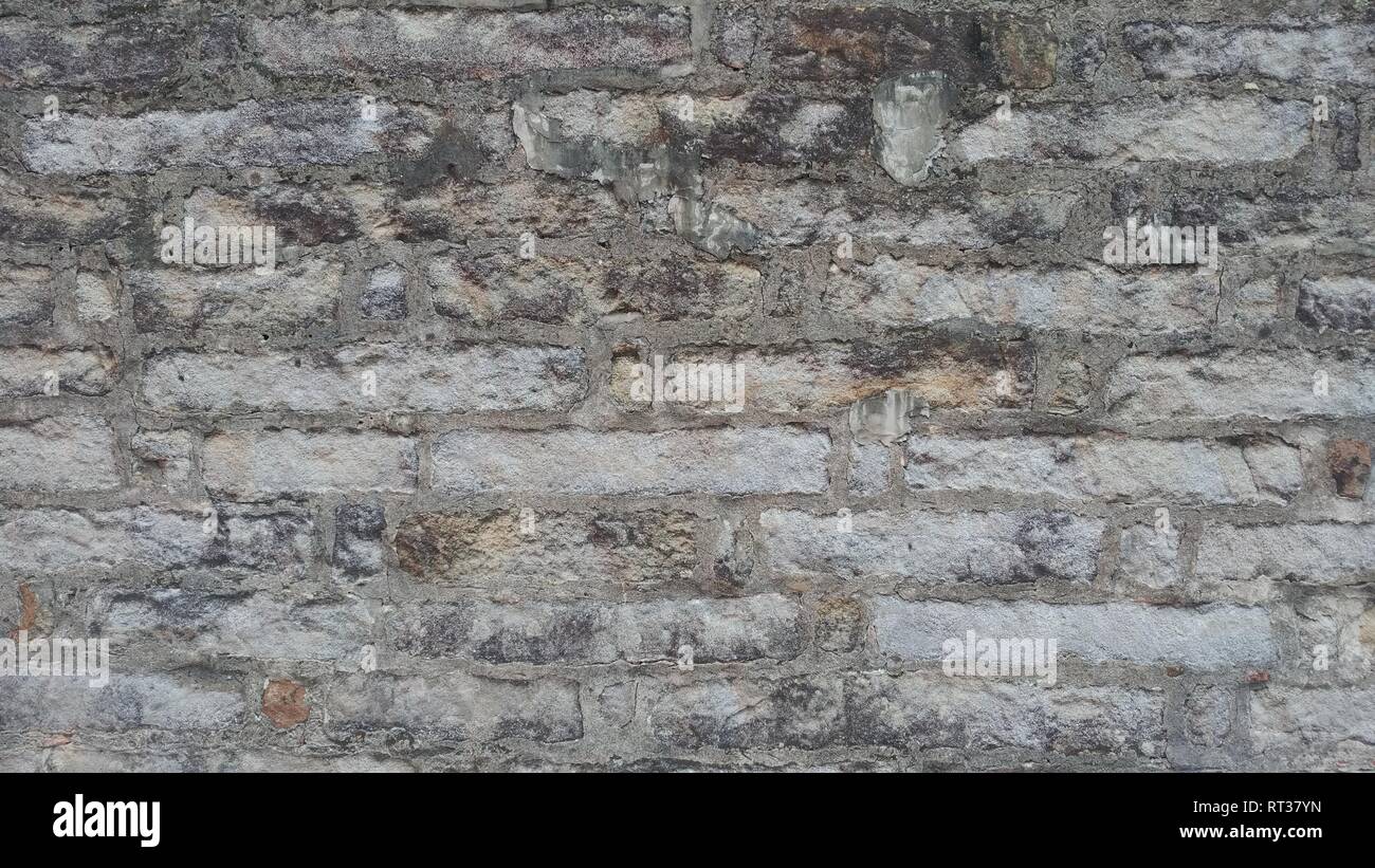 The Weathered stained old brick wall background Stock Photo - Alamy