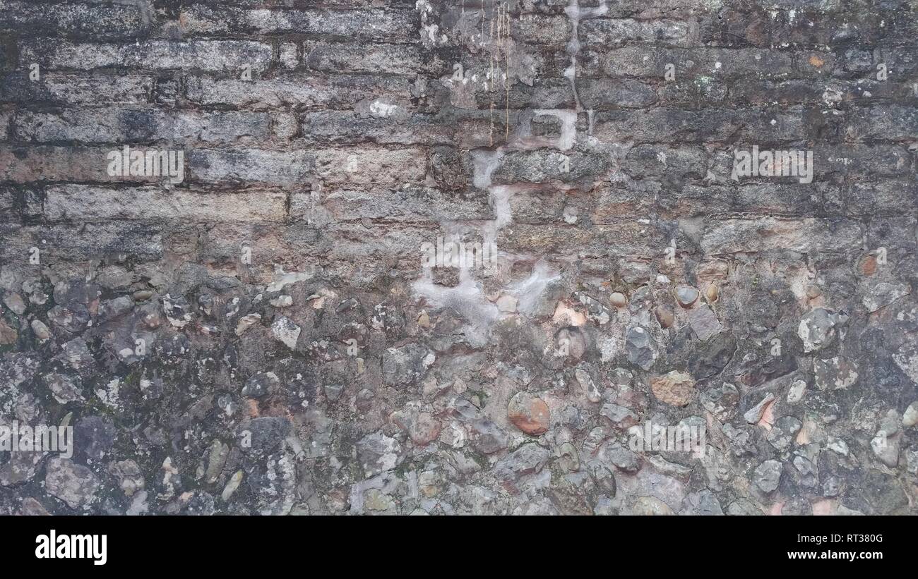 The Weathered stained old brick wall background Stock Photo - Alamy