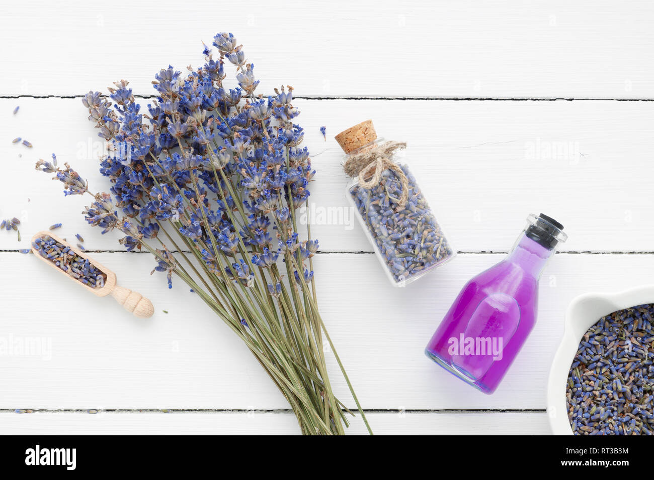 Bottle of essential oil or drink, mortar, lavender flowers on white ...
