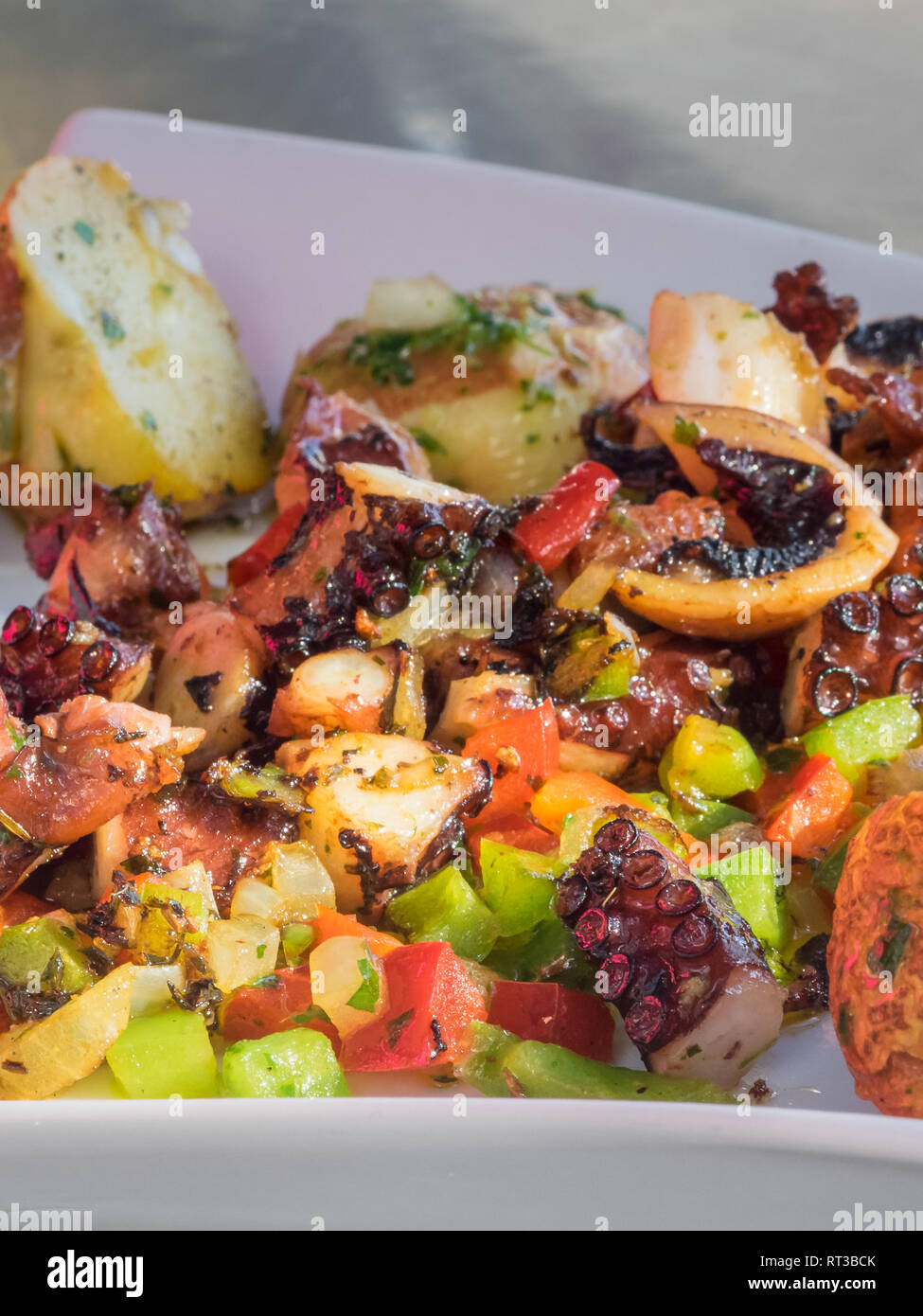 Octopus sauteed with vegetables. Hot octopus salpicon in Lanzarote. Canary island Stock Photo