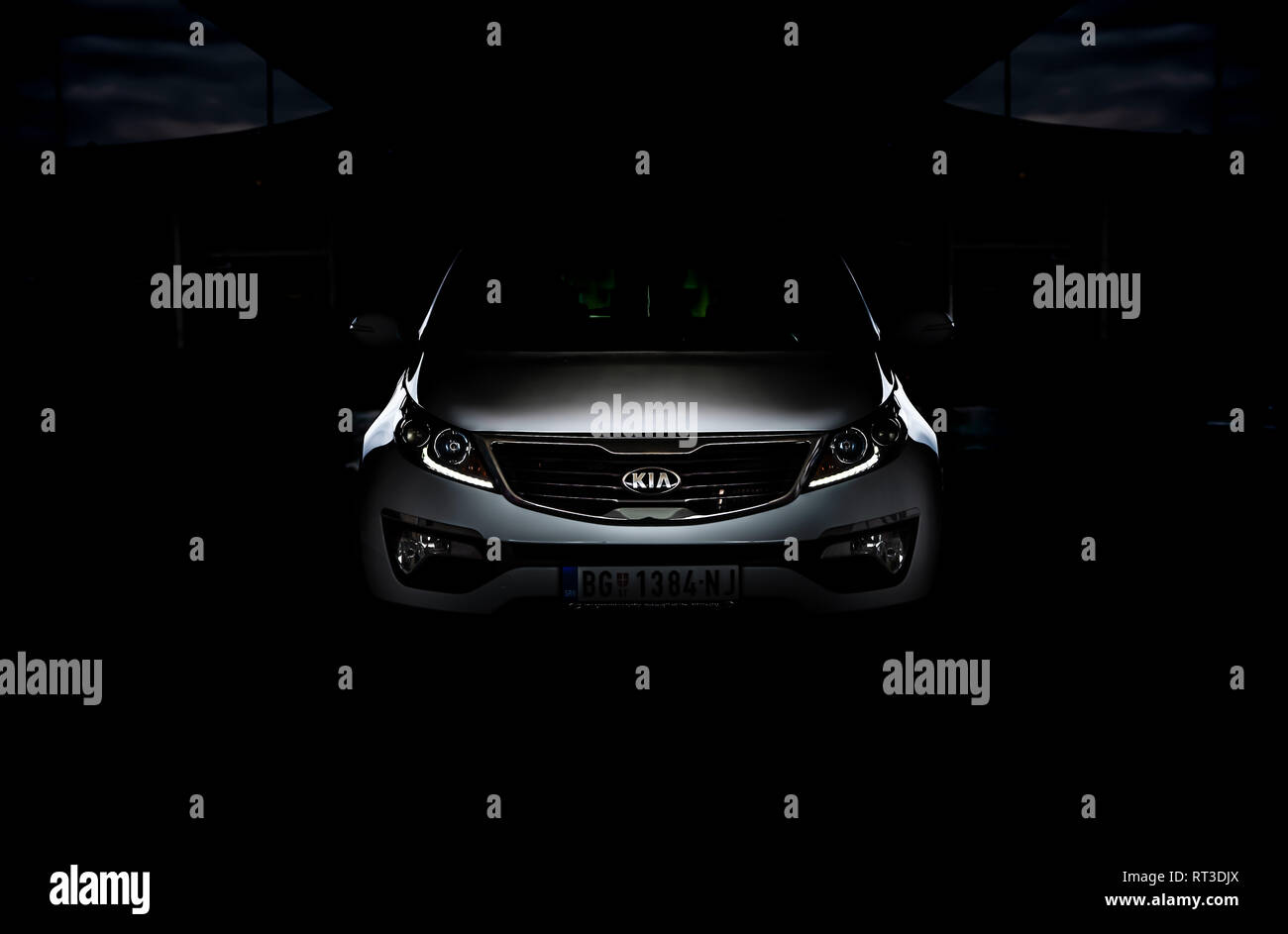 Photo of SUV Kia Sportage 2.0 CRDI awd or 4x4, a dark picture, so that you can only see the contours of the car design. It looks like beast in cave. Stock Photo