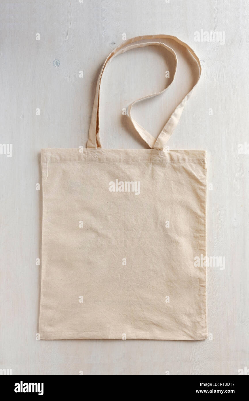Natural fiber neutral coloured re-usable shopping bag with handles laid flat on a white background Stock Photo