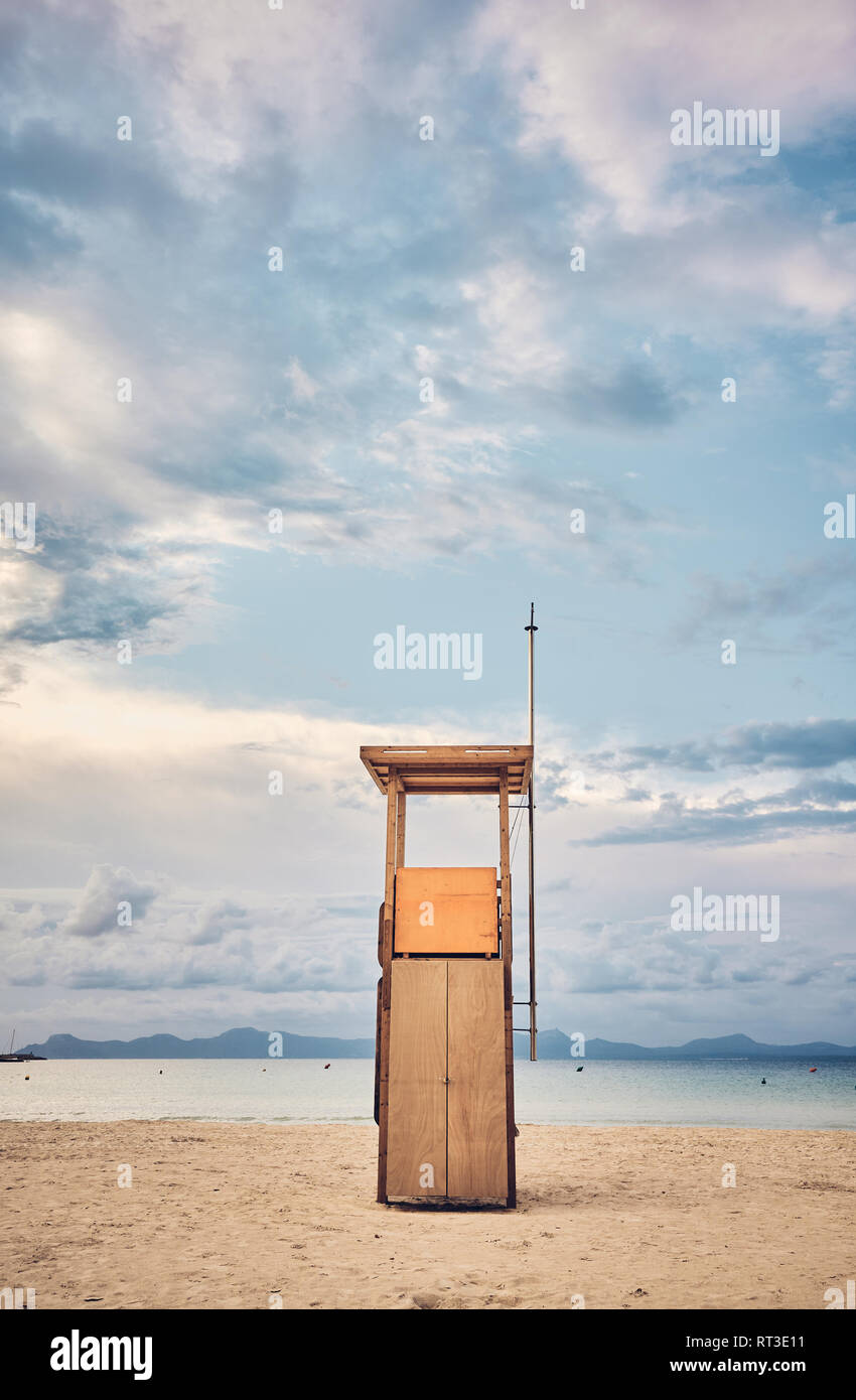 Lifeguard tower on an empty beach at sunset, color toned picture. Stock Photo