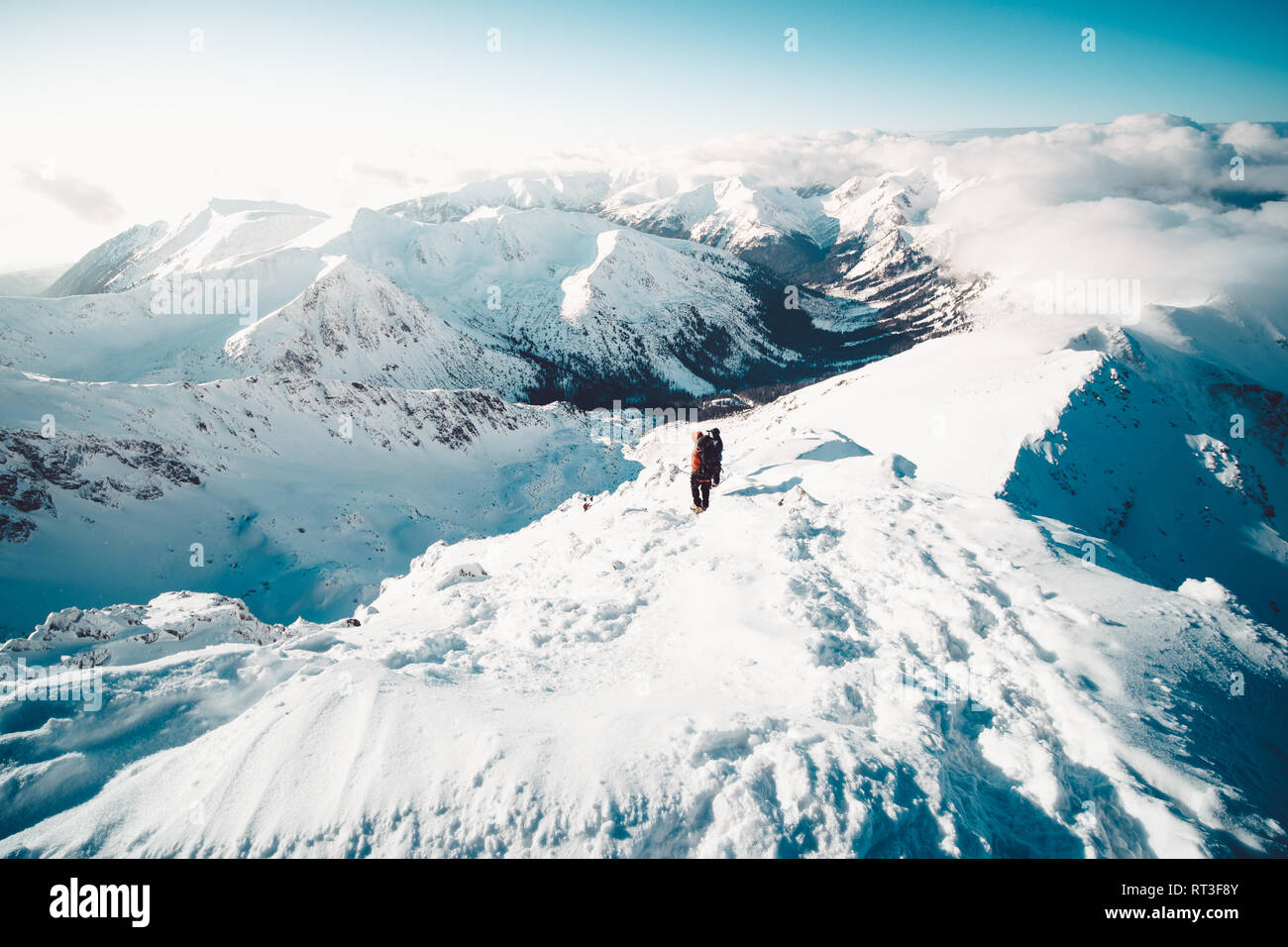 A climber ascending a mountain in winter Stock Photo