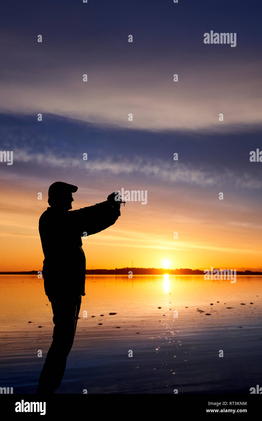 Man taking a picture at sunset, Borgarnes, Western Iceland Stock Photo