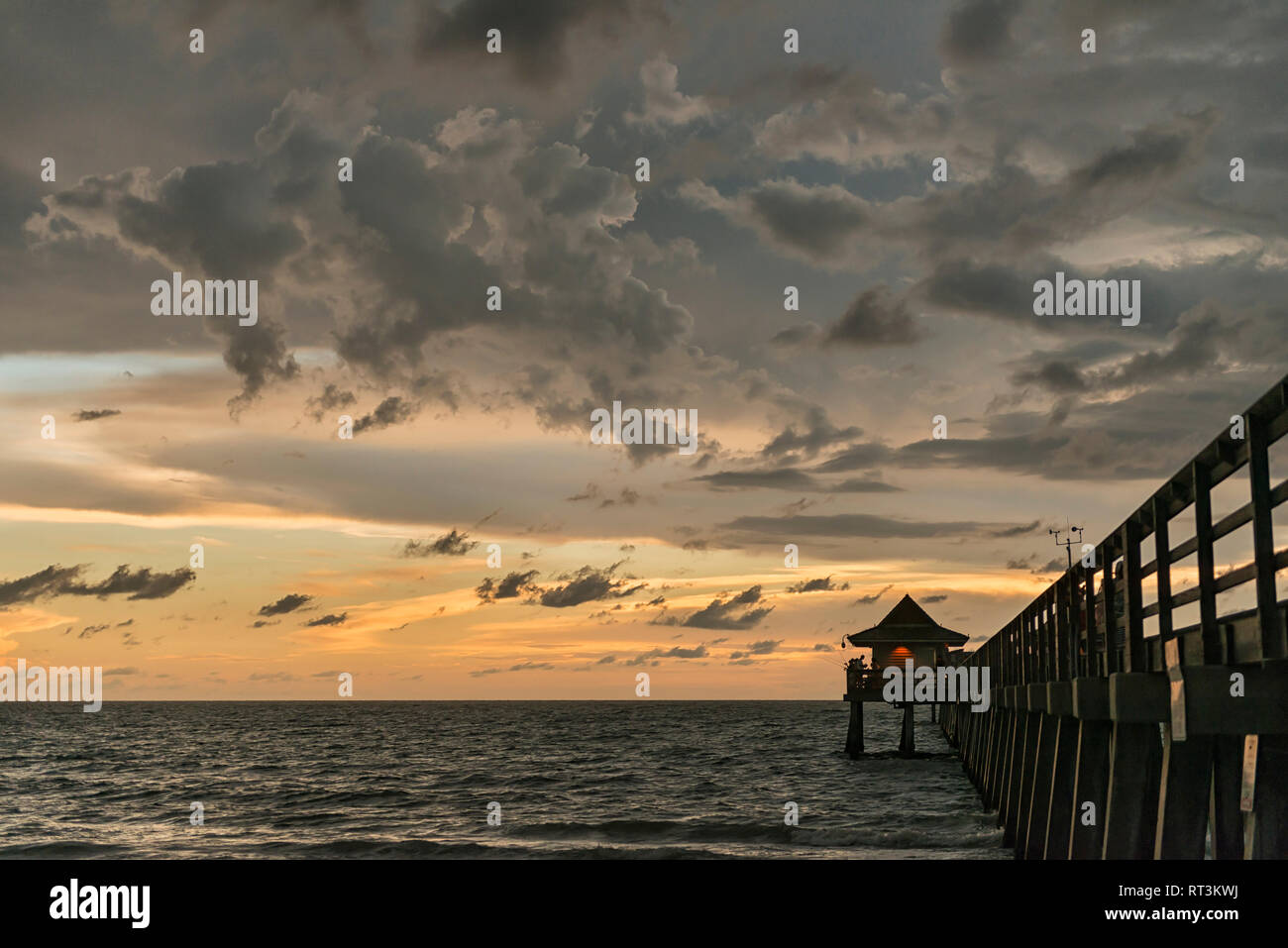 United States of America, Florida, Naples, silhouette of Naples Pier and dark clouds above during dusk Stock Photo