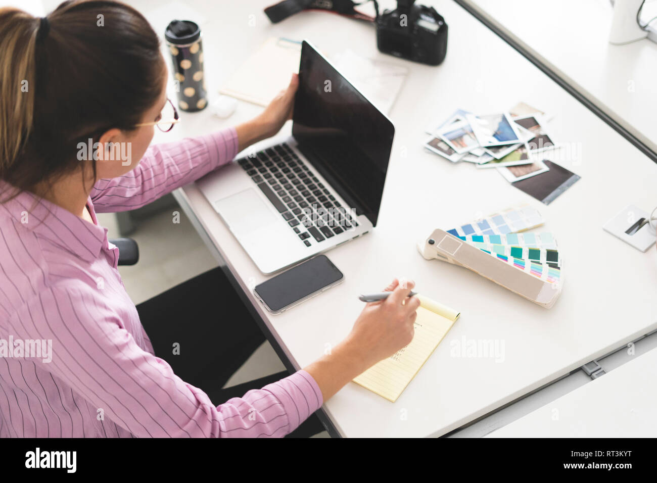Designer working in office, using laptop Stock Photo