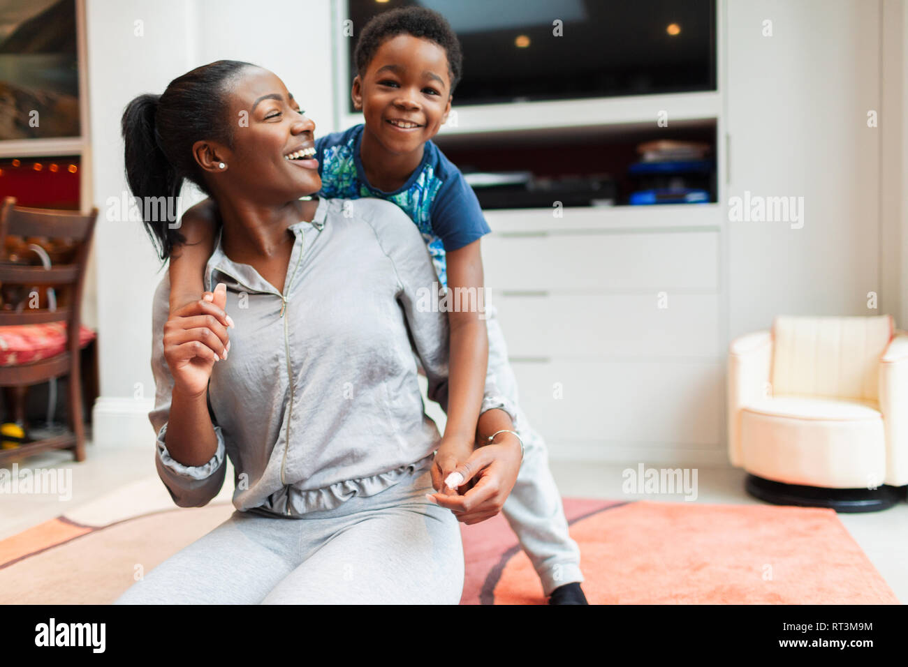 Portrait playful, happy mother and son in living room Stock Photo