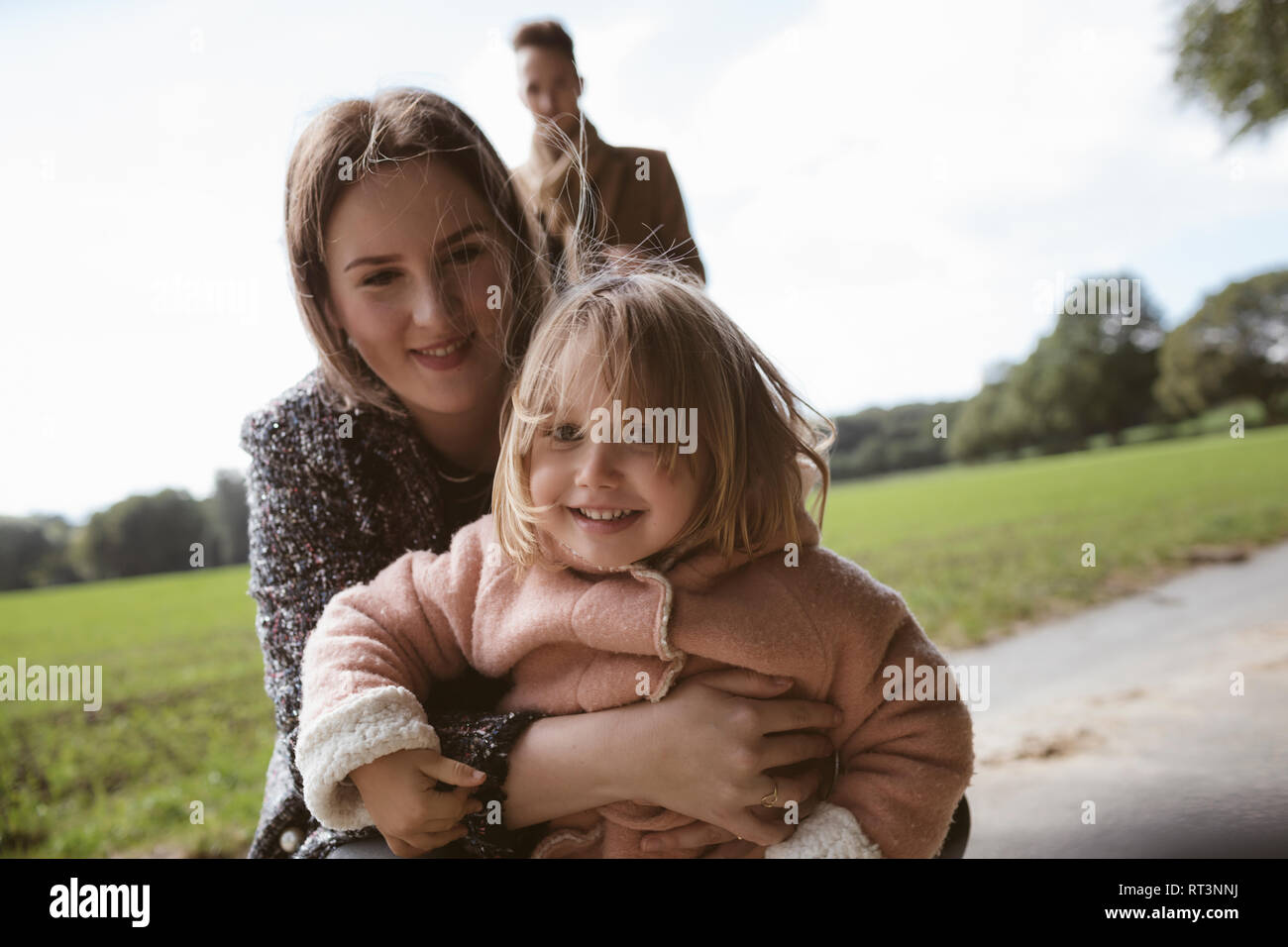 Portrait of happy blond little girl in her mothers arms Stock Photo - Alamy