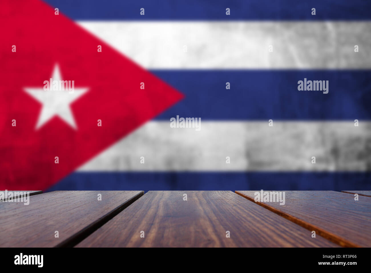 Wood Table Top Background and Grunge flag of Cuba on concrete wall ...