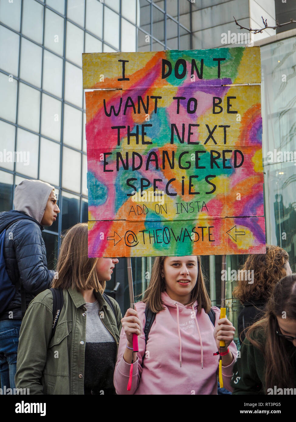 21 February 2019 - Brussels, Belgium: Young caucasian woman holding a handmade banner with slogan during a school strike for climate march Stock Photo