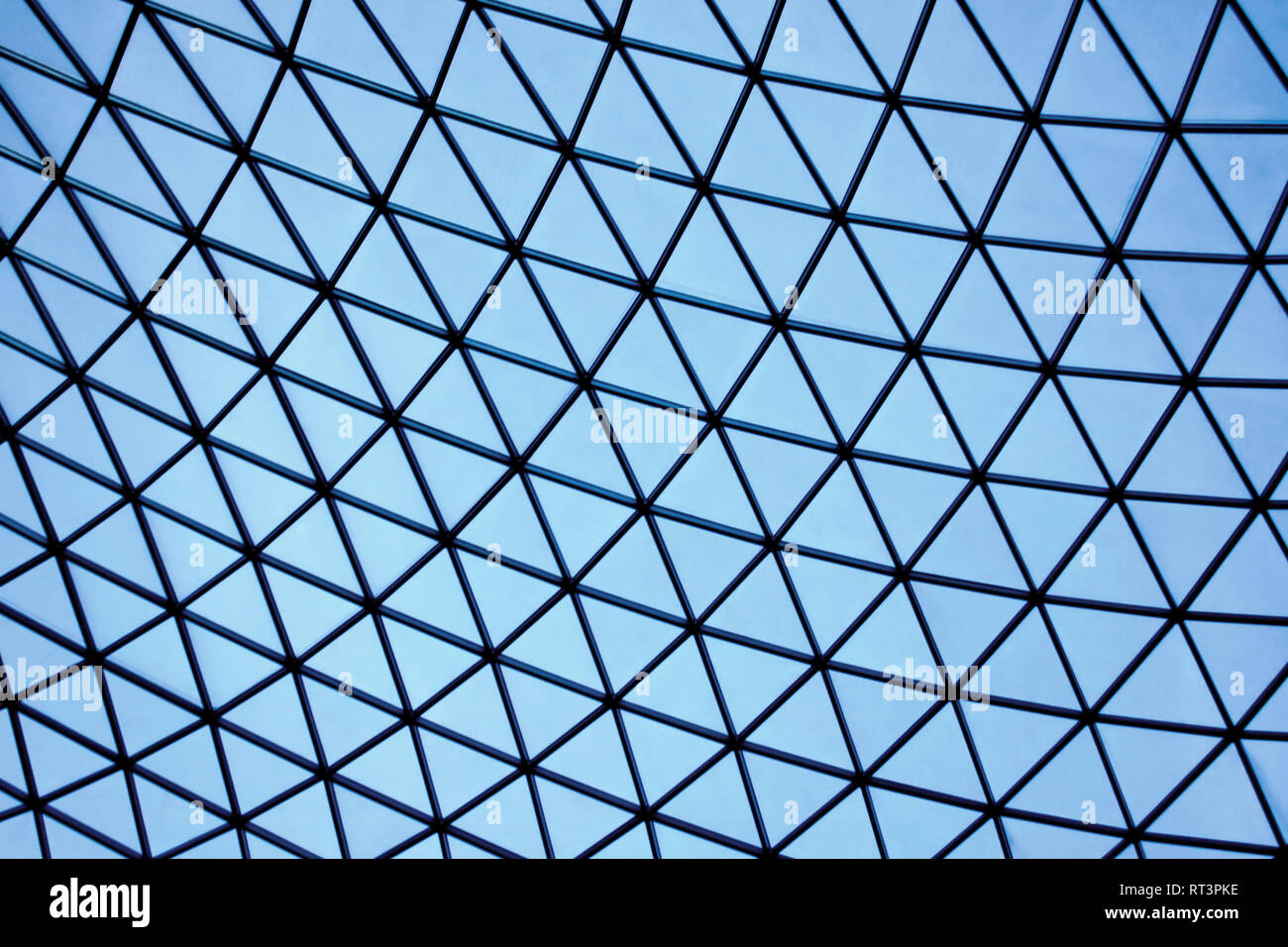 Geometric architectural construction of light blue glass triangles ...