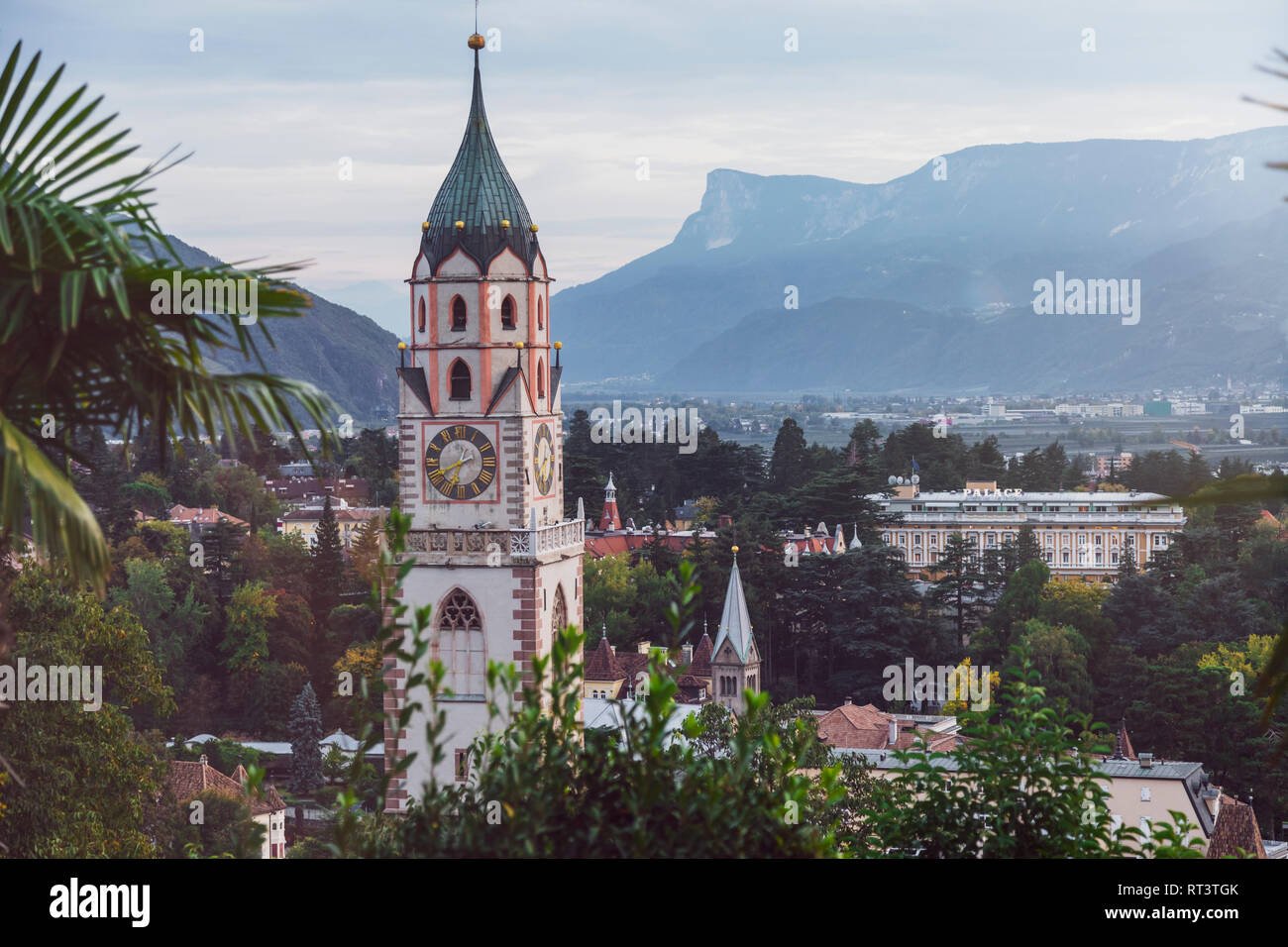 Italy, Alto Adige, Meran, cityscape with St. Nicholas' Church in the evening Stock Photo