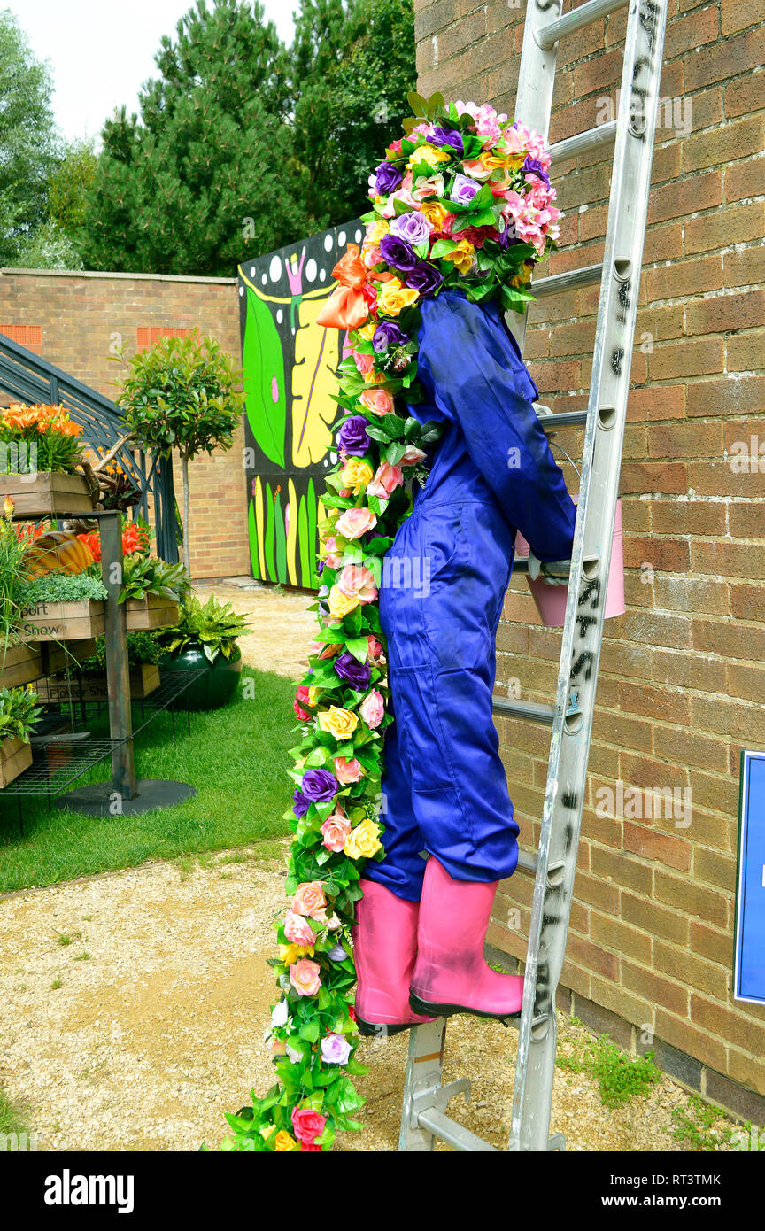 Rapunzel character with flowers used for hair climbing a ladder at the ...