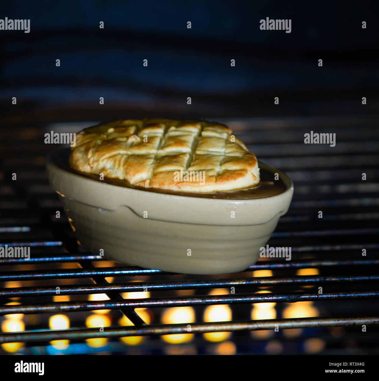 A pie cooking in a gas oven Stock Photo Alamy