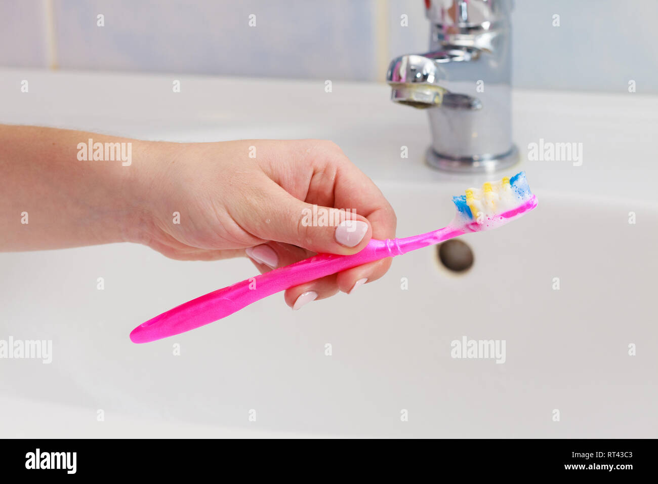 Dental care. Woman hands is holding toothbrush with toothpaste in ...
