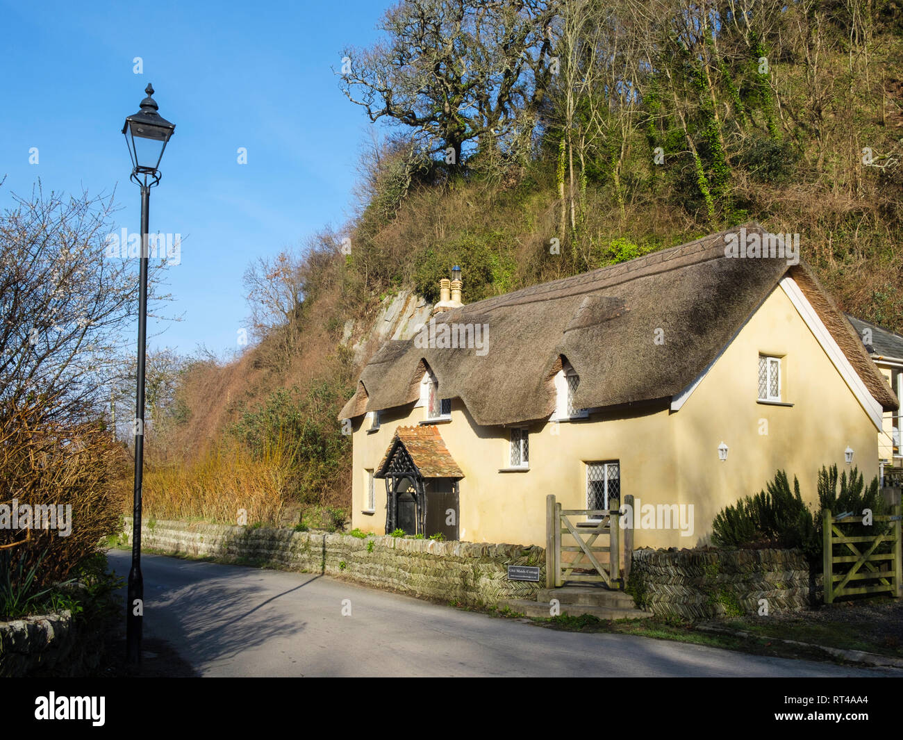 17th century Old Maids Cottage 1653 with a traditional thatched roof in pretty English country village of Lee, North Devon, England, UK, Britain Stock Photo