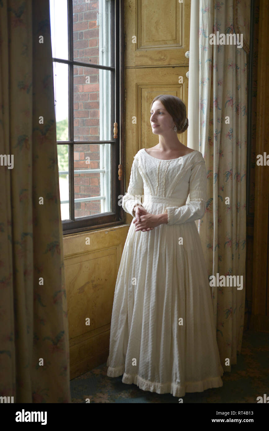 A beautiful young woman is dressed as Princess or young Queen Victoria