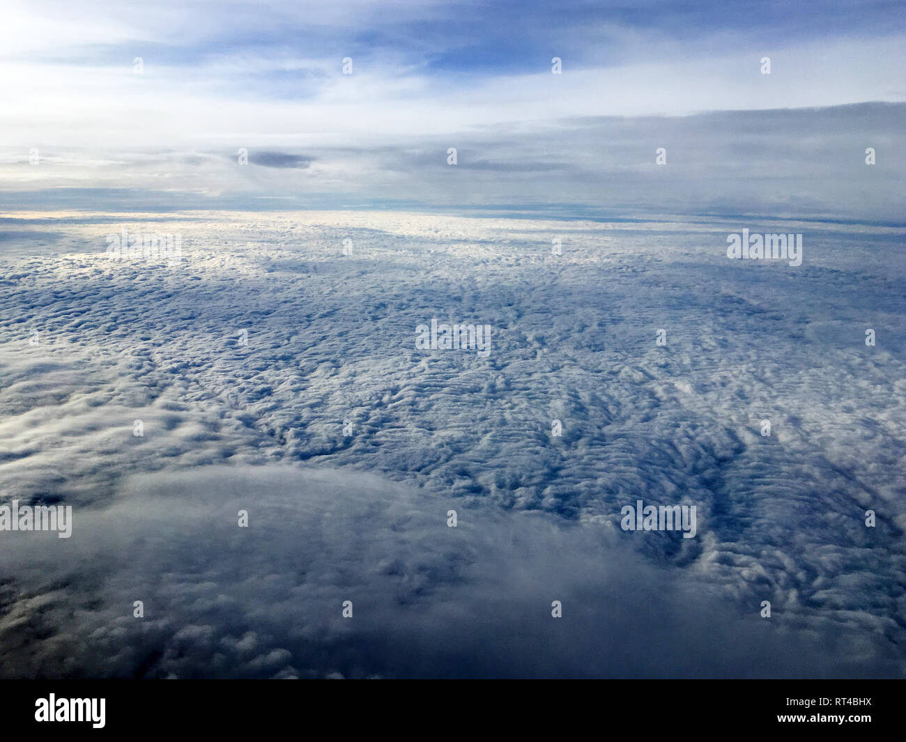 An aerial view from the airplane flying high above the ground. A look ...