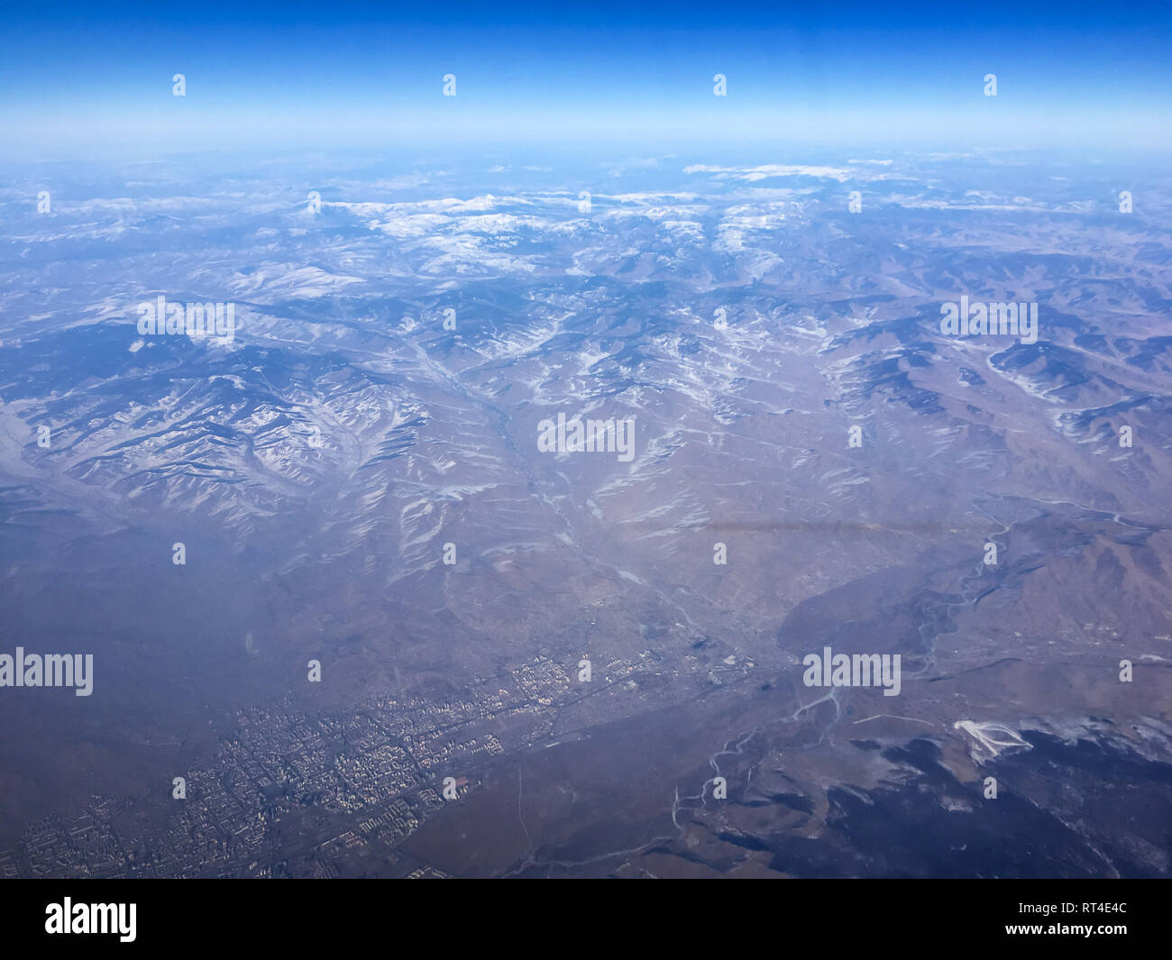 An aerial view of a part of Mongolia from the airplane flying high above the ground. A look from the plane´s window. A part of Oulanbatar can be seen. Stock Photo
