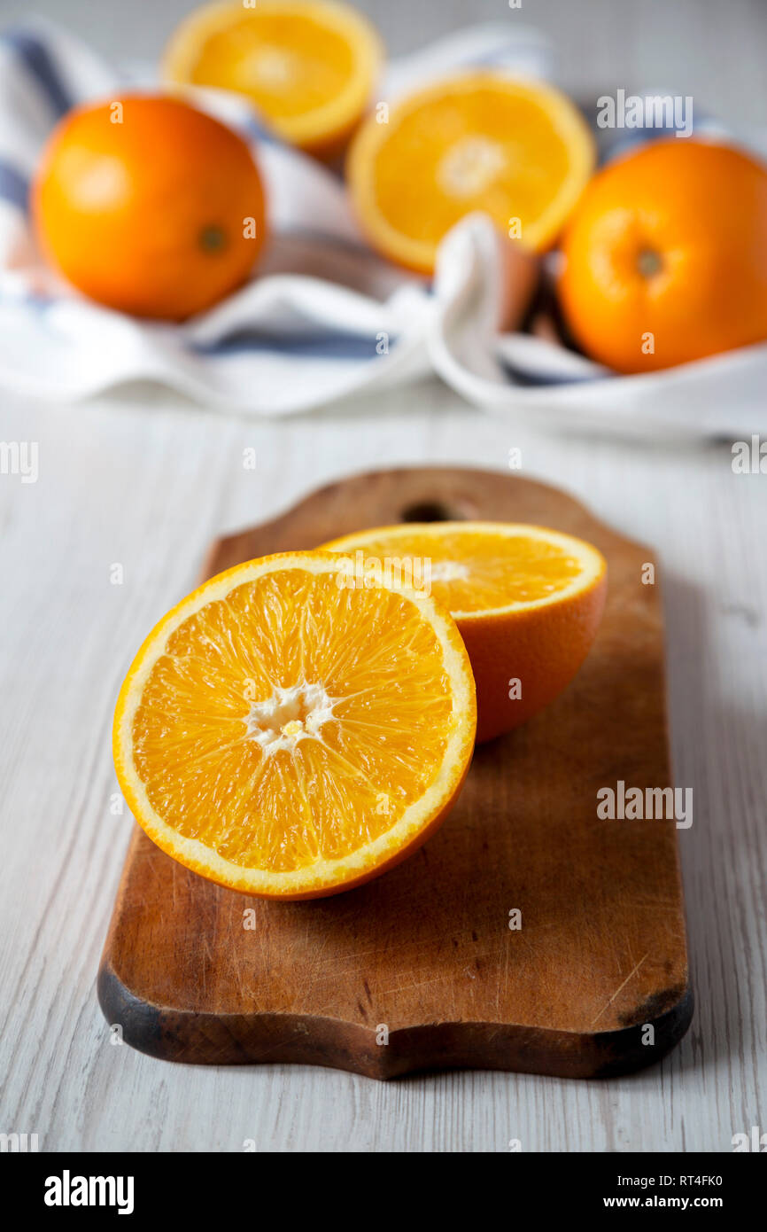 Halved and whole oranges, low angle view. Closeup. Stock Photo