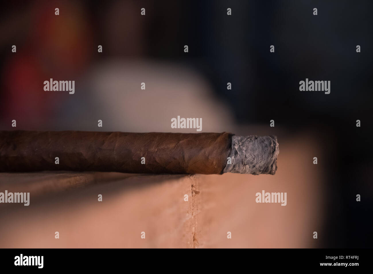 A single cigar sits on a wooden table in Viñales Cuba. Stock Photo