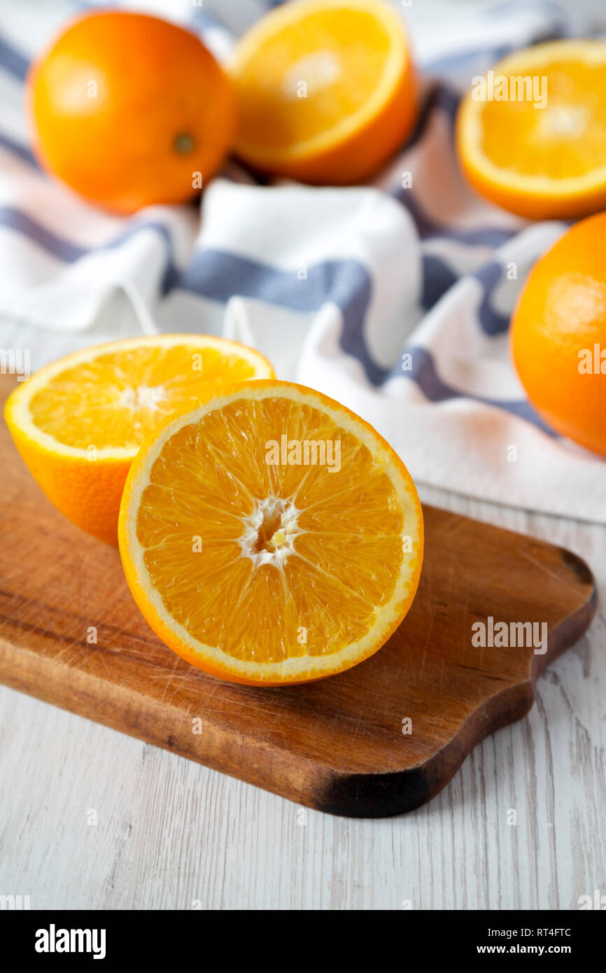Halved and whole oranges, side view. Closeup. Selective focus. Stock Photo
