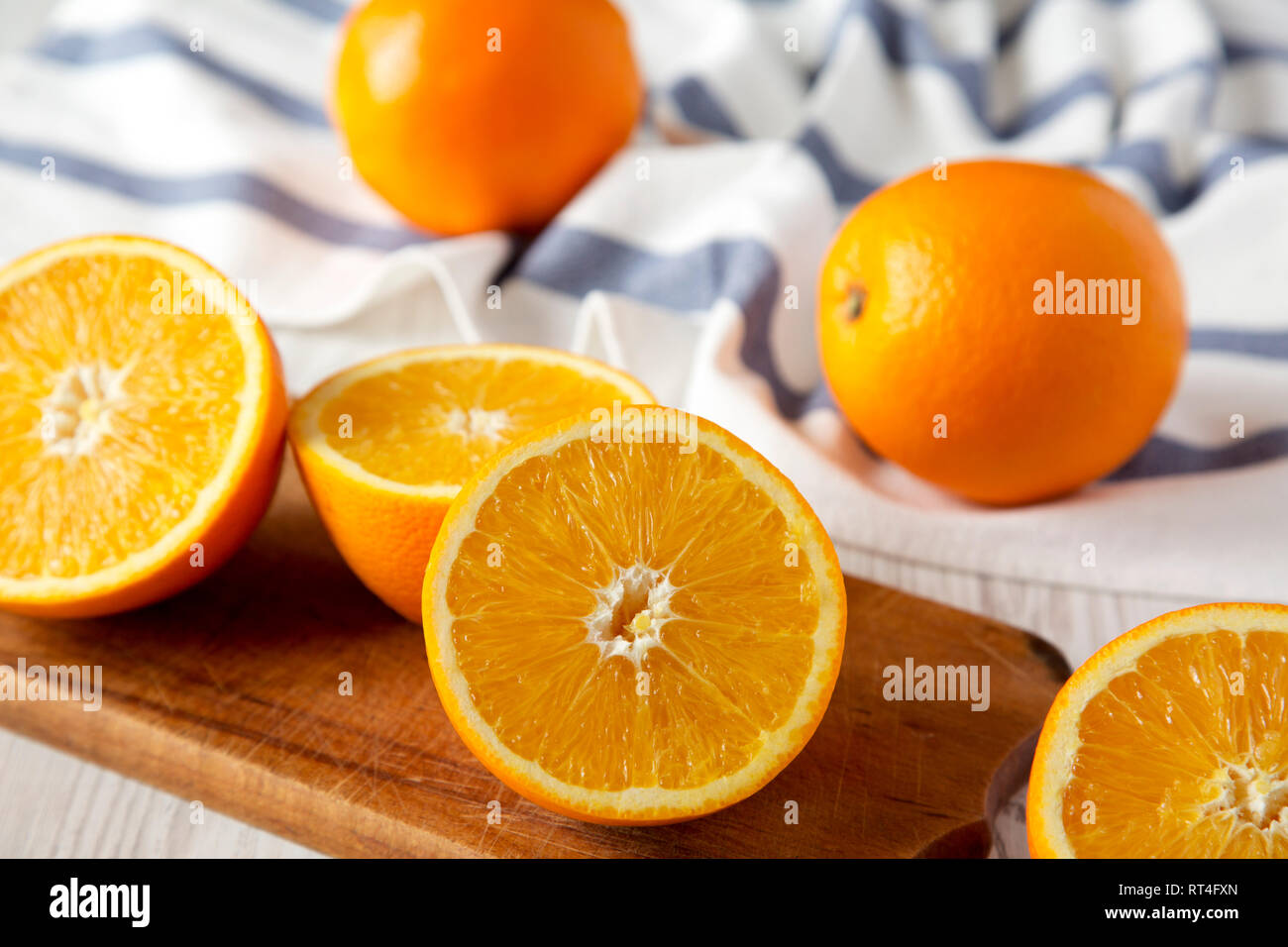 Halved and whole oranges, side view. Close-up. Selective focus. Stock Photo