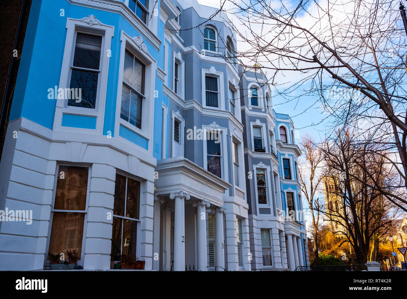 Brightly coloured house facades and All Saints Church, Notting Hill, London Stock Photo