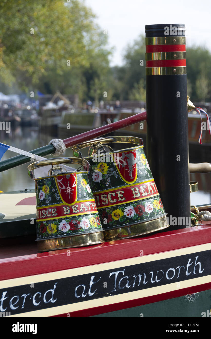 Hand painted water jugs on top of narrowboat Stock Photo