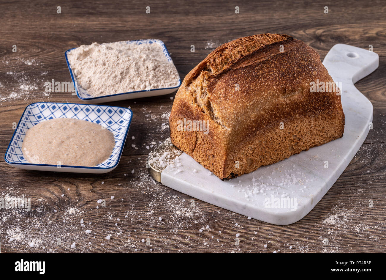 Artisan fresh sourdough bread on wooden table background Stock Photo