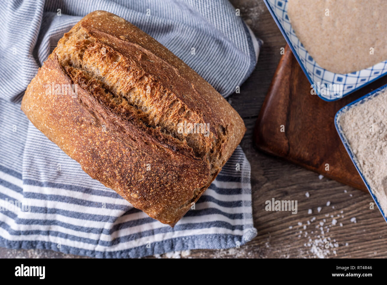 Artisan fresh sourdough bread on wooden table background Stock Photo